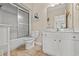 Cozy bathroom features a bathtub with glass shower doors, a toilet, and a vanity with a mirror at 113 B Vista Dr., Murrells Inlet, SC 29576