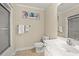Bright bathroom with white fixtures, neutral walls, decorative art, and ceramic tile floors at 113 B Vista Dr., Murrells Inlet, SC 29576