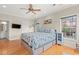 Bright bedroom with hardwood floors, ceiling fan and a king bed featuring a sea turtle motif at 113 B Vista Dr., Murrells Inlet, SC 29576
