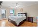 Bright bedroom with hardwood floors, ceiling fan and a king bed featuring a sea turtle motif at 113 B Vista Dr., Murrells Inlet, SC 29576
