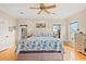 Bright bedroom with hardwood floors, ceiling fan and a king bed featuring a sea turtle motif at 113 B Vista Dr., Murrells Inlet, SC 29576