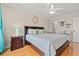 Bright bedroom with hardwood floors, ceiling fan and a king bed featuring a sea turtle motif at 113 B Vista Dr., Murrells Inlet, SC 29576