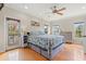 Bright bedroom with hardwood floors, ceiling fan and a king bed featuring a sea turtle motif at 113 B Vista Dr., Murrells Inlet, SC 29576