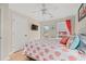 Cozy bedroom featuring a ceiling fan, mounted television, coral bedding, and access to an outdoor deck at 113 B Vista Dr., Murrells Inlet, SC 29576