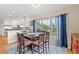 Dining area with wood table set, hardwood floors, natural light, and white kitchen in background at 113 B Vista Dr., Murrells Inlet, SC 29576