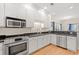 Clean kitchen with white cabinets, stainless steel appliances, granite countertops, and hardwood floors at 113 B Vista Dr., Murrells Inlet, SC 29576