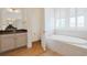 Bright bathroom featuring a soaking tub, and white cabinets at 1359 Peterson St., Myrtle Beach, SC 29577