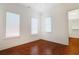 Bedroom with three windows, hardwood floors, and ensuite closet at 1359 Peterson St., Myrtle Beach, SC 29577