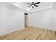 Bright bedroom with a ceiling fan, tray ceiling, hardwood floors, and an attached closet at 1359 Peterson St., Myrtle Beach, SC 29577
