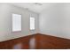 Bedroom with hardwood floors, two windows, and a ceiling fan at 1359 Peterson St., Myrtle Beach, SC 29577