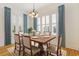 Elegant dining room features white shiplap, plantation shutters, and a stylish light fixture at 1359 Peterson St., Myrtle Beach, SC 29577