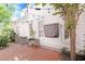 Private patio featuring brick pavers, string lights, and garden beds creating a cozy outdoor living space at 1359 Peterson St., Myrtle Beach, SC 29577