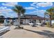 Clubhouse featuring shade, tables, ping pong, and lounge seating adjacent to an inviting outdoor pool area at 1359 Peterson St., Myrtle Beach, SC 29577