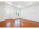 Bright room with hardwood floors, a ceiling fan and large windows at 1359 Peterson St., Myrtle Beach, SC 29577
