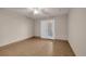 Neutral bedroom with tile flooring and glass doors to outdoor patio at 1361 Turkey Ridge Rd. # C, Surfside Beach, SC 29575