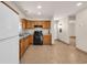 Neutral kitchen with wood cabinets, granite countertops and black oven at 1361 Turkey Ridge Rd. # C, Surfside Beach, SC 29575