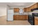 Traditional kitchen featuring wood cabinets, neutral countertop, and tile floors at 1361 Turkey Ridge Rd. # C, Surfside Beach, SC 29575