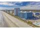 Wide aerial shot of resort property with a sandy beach, including buildings, a pool, and parking areas at 1501 S Ocean Blvd. # 320, Myrtle Beach, SC 29577