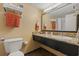 This bathroom features granite countertops, a vanity mirror, towels, and a toilet at 1501 S Ocean Blvd. # 320, Myrtle Beach, SC 29577