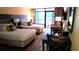 Comfortable bedroom with two beds, a balcony, and cozy seating area at 1501 S Ocean Blvd. # 320, Myrtle Beach, SC 29577