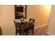Cozy dining area with dark wood table and chairs, next to kitchenette at 1501 S Ocean Blvd. # 320, Myrtle Beach, SC 29577