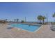 Outdoor swimming pool surrounded by lounge chairs and palm trees on a sunny day with ocean views at 1501 S Ocean Blvd. # 320, Myrtle Beach, SC 29577