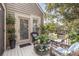 A balcony has wicker furniture, cozy cushions and views of trees and greenery at 1608 Harbor Dr., North Myrtle Beach, SC 29582