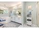A traditional-style bathroom with double sinks, a large mirror, white cabinets, a soaking tub and blue accents at 1608 Harbor Dr., North Myrtle Beach, SC 29582