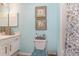 Stylish bathroom with light blue walls, patterned shower curtain, and nautical-themed decor at 1608 Harbor Dr., North Myrtle Beach, SC 29582