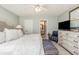Bright bedroom featuring a comfortable bed, dresser, and convenient access to a bathroom at 1608 Harbor Dr., North Myrtle Beach, SC 29582