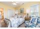 Comfortable bedroom with patterned bedding, bright natural light, and an ensuite bathroom at 1608 Harbor Dr., North Myrtle Beach, SC 29582