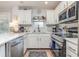 Well-lit kitchen featuring white cabinets, quartz countertops, stainless steel appliances, and modern fixtures at 1608 Harbor Dr., North Myrtle Beach, SC 29582