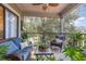 Cozy screened porch with wicker furniture and lush greenery offers a relaxing outdoor space at 1608 Harbor Dr., North Myrtle Beach, SC 29582