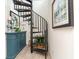 A home interior featuring a black spiral staircase and a blue dresser with decorative items at 1608 Harbor Dr., North Myrtle Beach, SC 29582