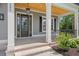 Charming front porch with a wood ceiling and black trimmed windows at 209 Bouquets Green Way, Myrtle Beach, SC 29579