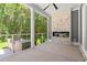 Inviting screened-in porch with fireplace and built-in grill area at 209 Bouquets Green Way, Myrtle Beach, SC 29579