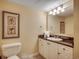 Cozy bathroom featuring white vanity, granite countertop, artwork and a toilet at 2151 Bridge View Ct. # 2-803, North Myrtle Beach, SC 29582