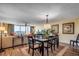 Inviting dining area with a modern table, stylish chairs, wood-look flooring, and expansive views from large windows at 2151 Bridge View Ct. # 2-803, North Myrtle Beach, SC 29582