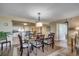 Open dining room with modern light fixture, seating for six, and wood-look floors at 2151 Bridge View Ct. # 2-803, North Myrtle Beach, SC 29582