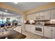 Modern kitchen with white cabinets, granite countertops, tile backsplash, stainless steel appliances, and a double sink at 2151 Bridge View Ct. # 2-803, North Myrtle Beach, SC 29582