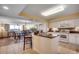 Open-concept kitchen boasts white cabinetry, dark countertops, tile backsplash, and views of the dining and living areas at 2151 Bridge View Ct. # 2-803, North Myrtle Beach, SC 29582