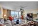 Inviting living room with comfortable seating, large windows and sliding glass doors with water view at 2151 Bridge View Ct. # 2-803, North Myrtle Beach, SC 29582