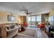 Bright and airy living room featuring comfortable seating, a ceiling fan, and access to a balcony with scenic views at 2151 Bridge View Ct. # 2-803, North Myrtle Beach, SC 29582