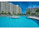 Inviting outdoor pool with sun deck and stunning high-rise buildings in the backdrop at 2151 Bridge View Ct. # 2-803, North Myrtle Beach, SC 29582