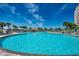 Expansive outdoor pool area with palm trees and plenty of space to lounge around at 2151 Bridge View Ct. # 2-803, North Myrtle Beach, SC 29582
