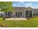 Home backyard featuring a brick patio, outdoor seating, mature trees, and partial screening at 2446 Craven Dr., Myrtle Beach, SC 29572