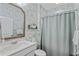 Bathroom with a white vanity, toilet, shower and a green bamboo wallpaper design at 2446 Craven Dr., Myrtle Beach, SC 29572