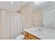 Bathroom featuring a vanity, toilet, shower with decorative shower curtain and updated lighting at 2446 Craven Dr., Myrtle Beach, SC 29572