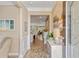 Inviting foyer with decorative wall trim and wood-look tile flooring, plus a glimpse into the open concept living spaces at 2446 Craven Dr., Myrtle Beach, SC 29572