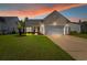 Charming single Gathering home featuring a well maintained lawn, an attached two car garage, and a welcoming front entrance at 2446 Craven Dr., Myrtle Beach, SC 29572